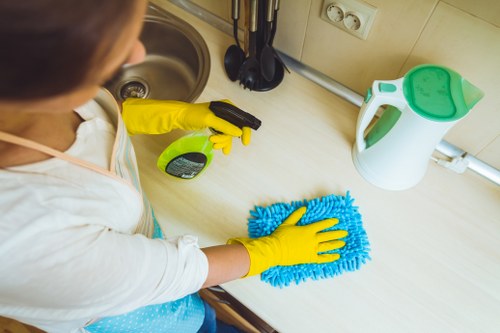 Local cleaner treating stains on a sofa in NW2